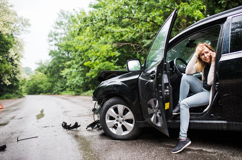 Woman sitting in a damaged car seeks a Myrtle Beach personal injury lawyer