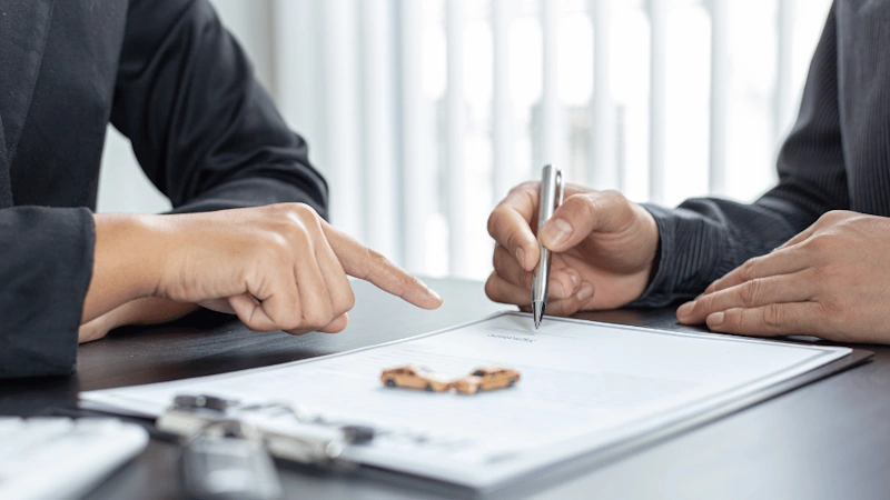 Car accident lawyers in Myrtle Beach reviewing a case with one signing a document